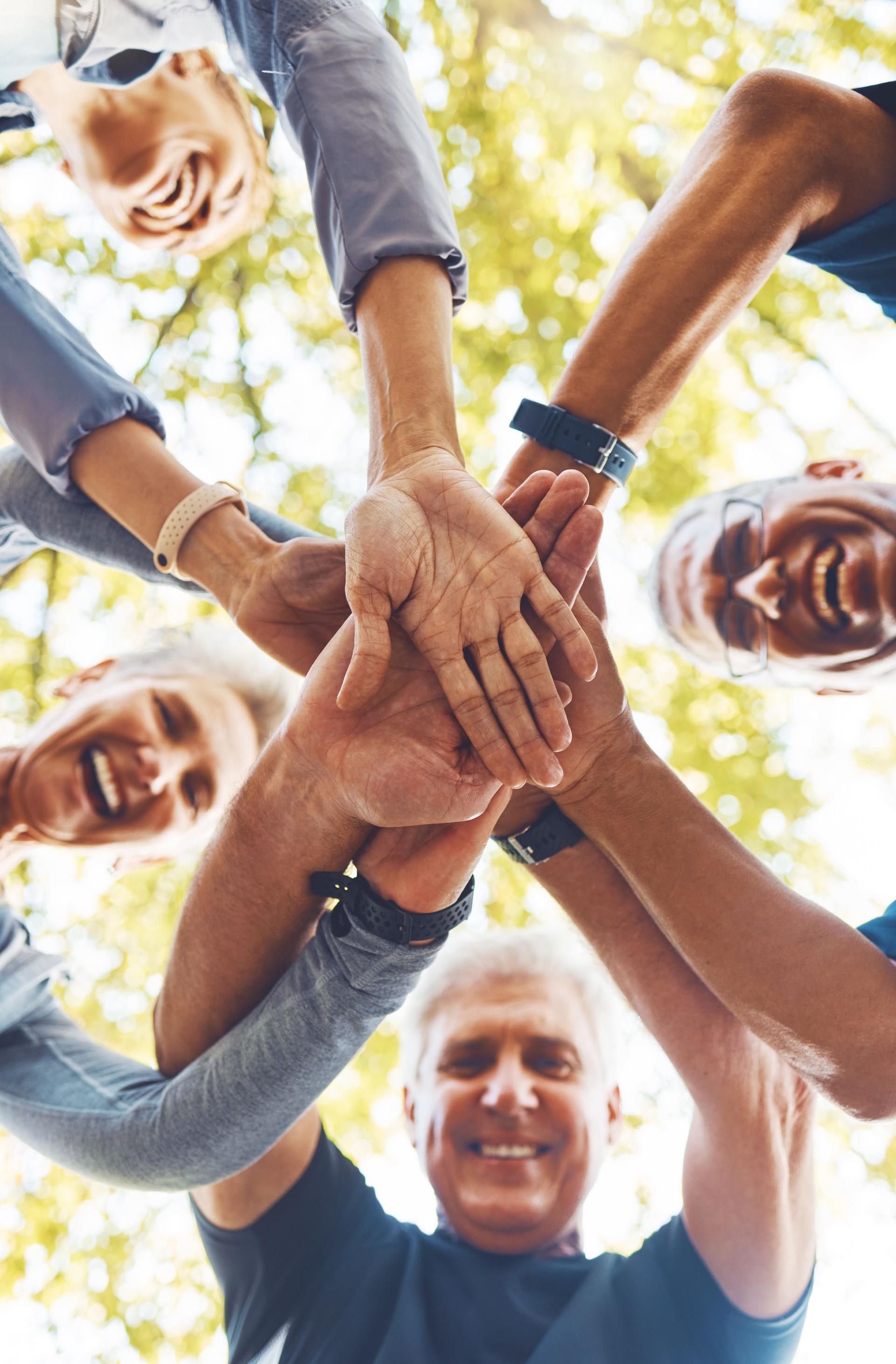 Senior hands, together and support with solidarity outdoor and group diversity with team building in nature. Trust, respect and mission with mature community, hand stack low angle and collaboration.