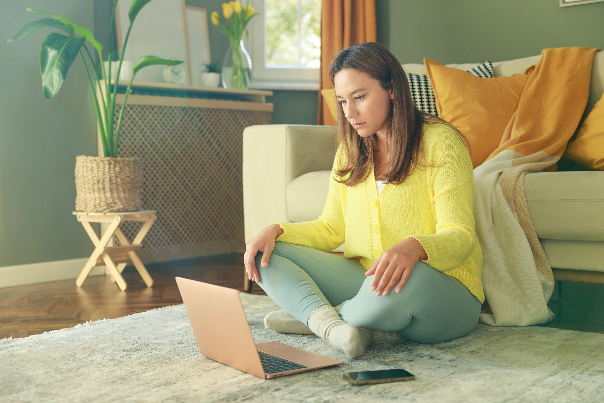 Young woman using her laptop at home
